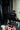 Person sitting on a bench in a gym with a punching bag and gym equipment around